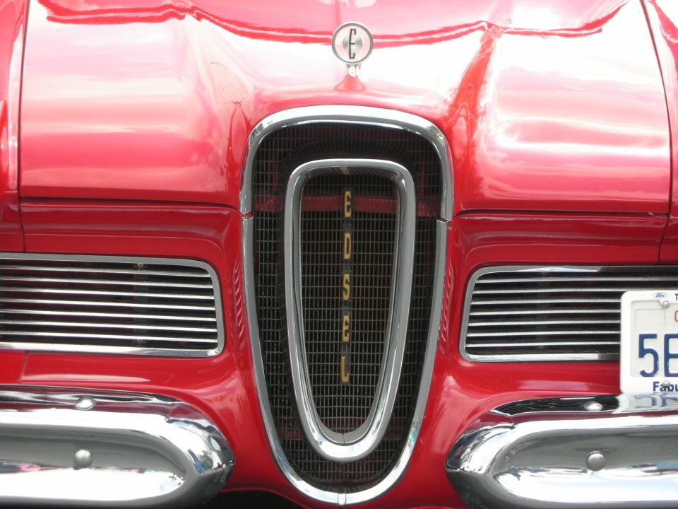 Red car front with chrome grille spelling "EDSEL" and horizontal vents