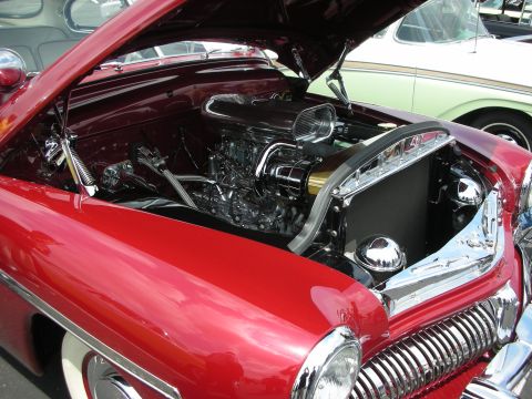 1992 Ford Crown Victoria - Customized V8 engine bay of a classic red car, with another vehicle in the background.