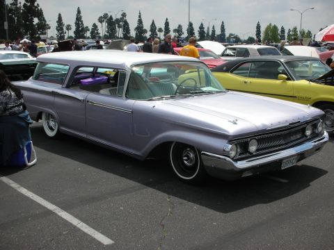 1992 Ford Crown Victoria - A lavender 1960 Mercury Colony Park station wagon is parked at a car show.