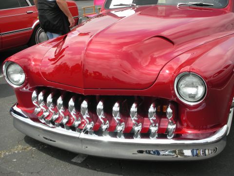 1992 Ford Crown Victoria - Front view of a heavily customized red hot rod with a distinctive chrome grille.