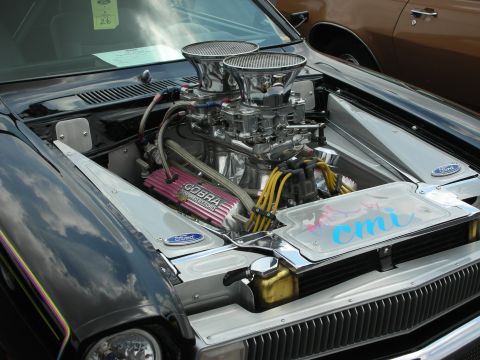 1992 Ford Crown Victoria - Custom V8 engine with chrome accents and performance parts, parked next to another vehicle.