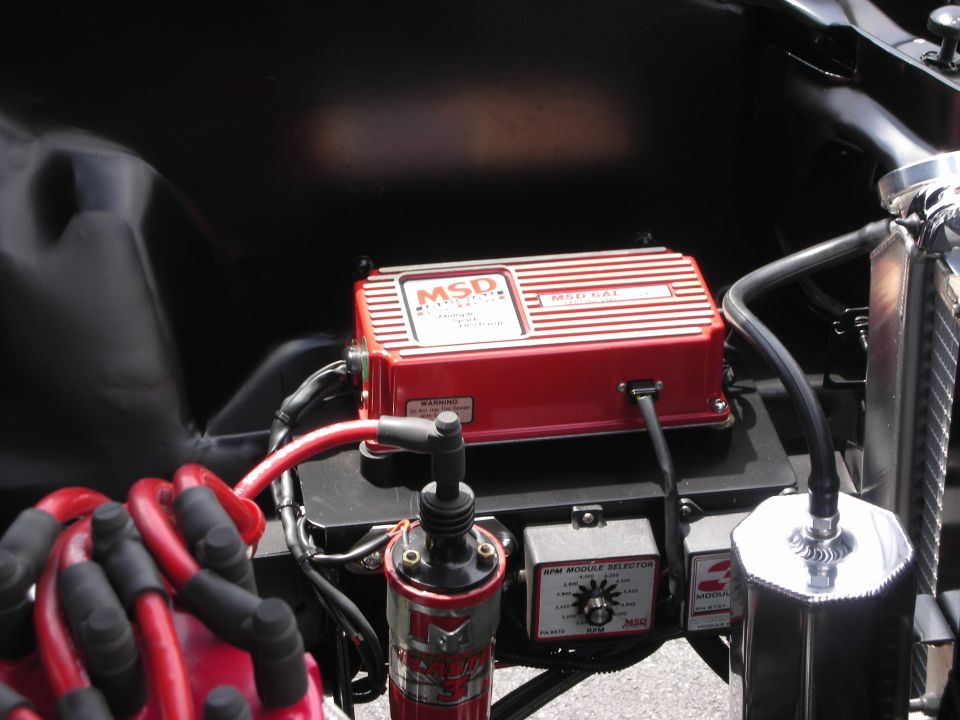 Red MSD ignition box and distributor in an engine bay