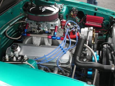 1992 Ford Crown Victoria - Close-up of a V8 engine bay a chrome air cleaner, blue spark plug wires, and a red ignition box.