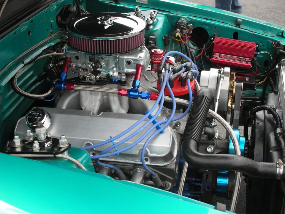 Engine bay with V8 engine, chrome air cleaner, and red ignition box