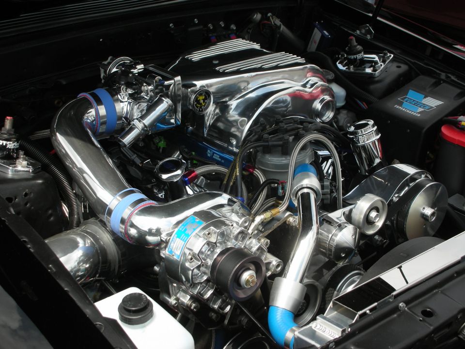 Polished chrome supercharger and intake piping in engine bay