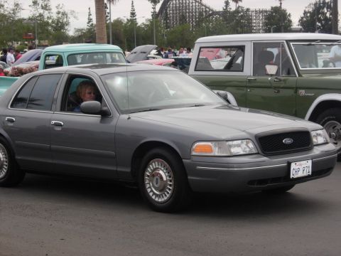 1992 Ford Crown Victoria - A gray 2003 Ford Crown Victoria is parked at an outdoor event with other vehicles.