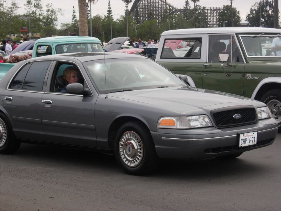 Gray 2003 Ford Crown Victoria, front quarter view, driver visible, license plate CHP P71