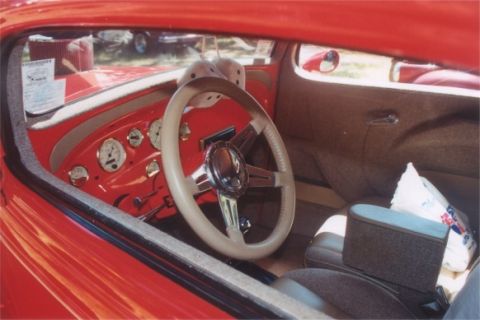 2002 Ford Crown Victoria - The interior of this classic car features a custom dashboard with multiple gauges and a vintage steering wheel.