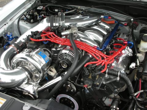 1992 Ford Crown Victoria - Close-up of a modified engine bay, a prominent supercharger and custom wiring.