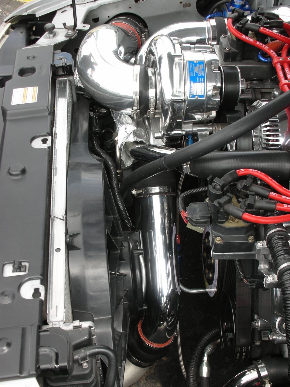 Chrome supercharger and engine components in a vehicle's engine bay