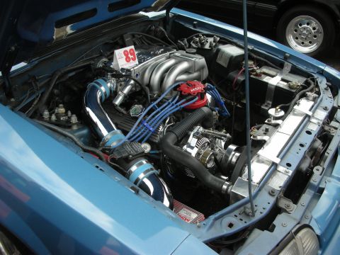 1992 Ford Crown Victoria - The engine bay of a blue car is shown, with a prominent '89' sign on the engine.
