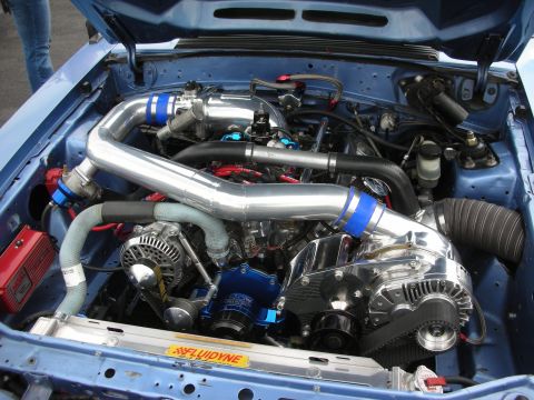 1992 Ford Crown Victoria - The engine bay features a polished supercharger and custom intake piping, suggesting significant modifications.