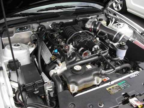 1992 Ford Crown Victoria - Close-up of a modified V8 engine with a prominent supercharger and custom intake system.
