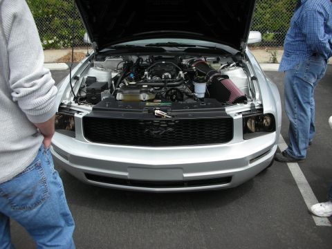 1992 Ford Crown Victoria - Front view of a silver Ford Mustang with its engine exposed.