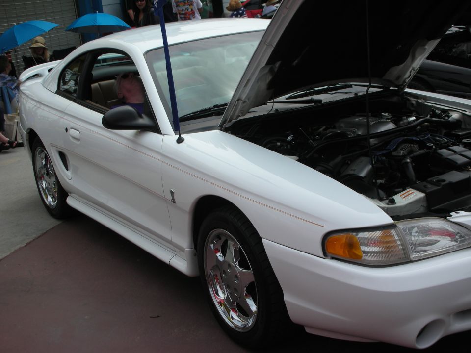 White 1994 Ford Mustang GT coupe, hood open, showing engine