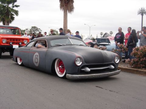 1992 Ford Crown Victoria - A custom hot rod with a matte gray finish and racing-inspired markings is displayed at a car show.