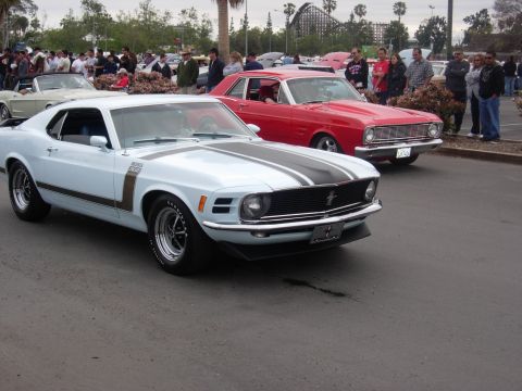 1992 Ford Crown Victoria - A light blue 1970 Ford Mustang Boss 302 is parked at a car show with other vehicles.