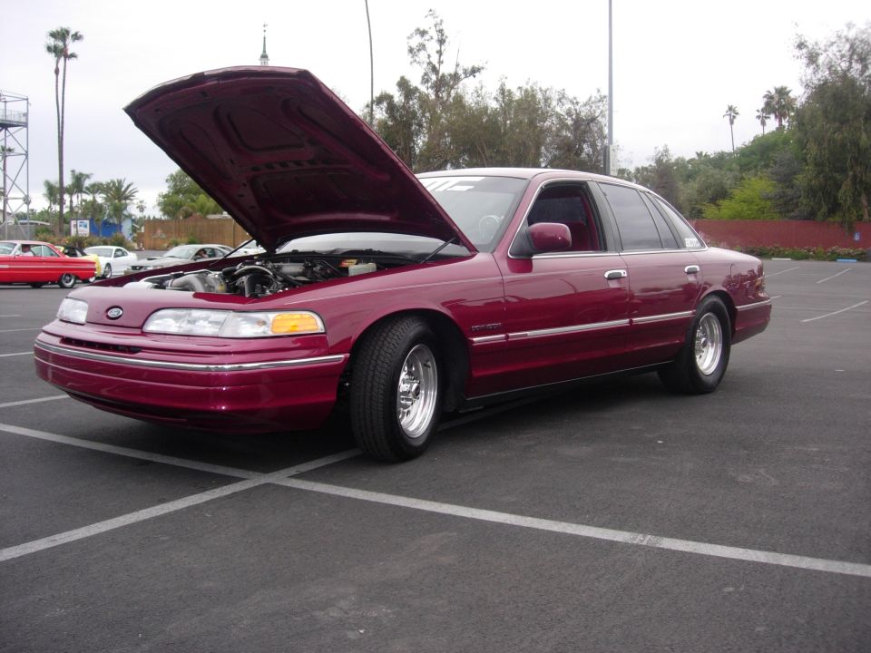 Maroon 1992 Ford Crown Victoria with hood open, parked in a lot