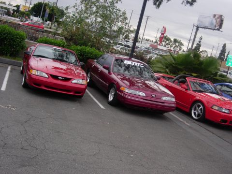 1992 Ford Crown Victoria - Three cars, including a 1992 Ford Crown Victoria, are parked in an outdoor lot.