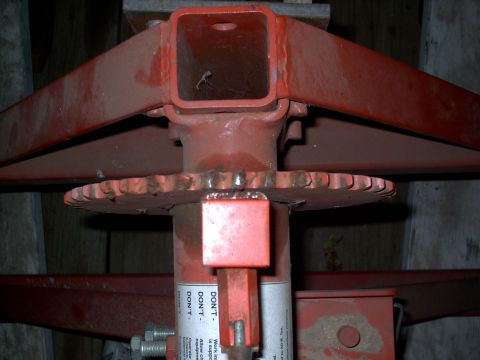 1965 Ford Mustang - A close-up view of a red metal jack mechanism, a toothed wheel and a warning label with instructions.