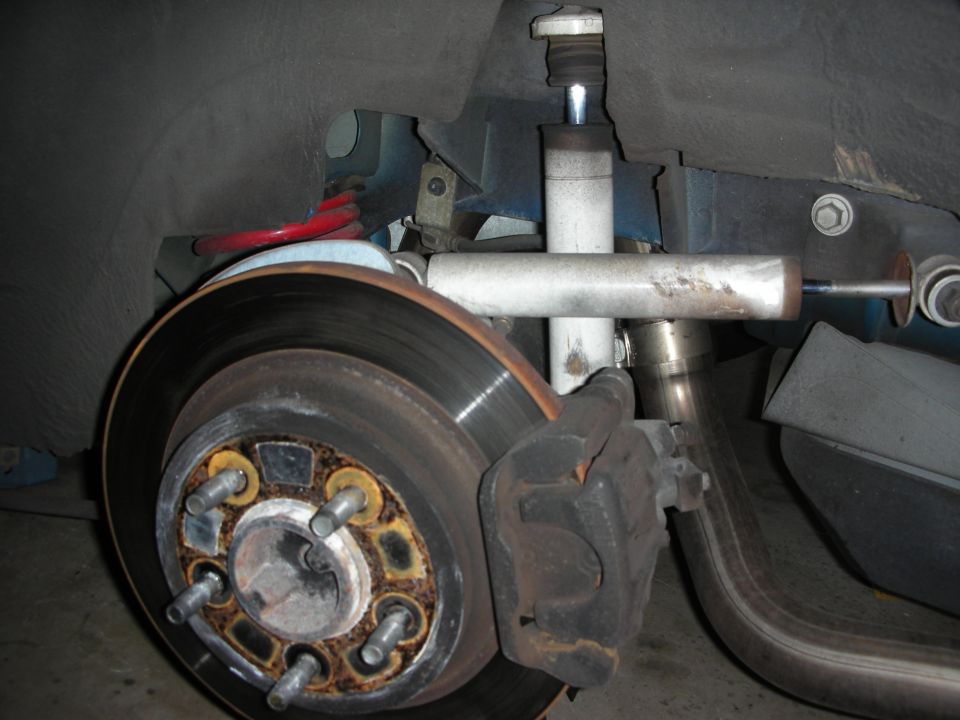 Front disc brake assembly with caliper, rotor and suspension on a lifted car