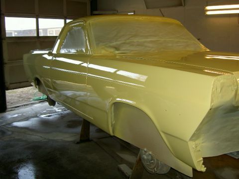 1967 Ford Ranchero - A vehicle is being prepped for paint in a garage, with masking covering the windows and some body panels.