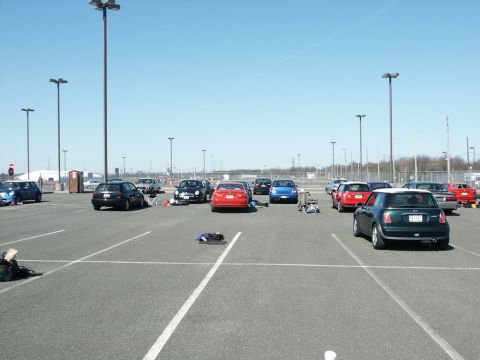 2001 Mercury Grand Marquis - A variety of cars are parked in an outdoor lot under a clear blue sky.