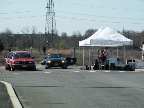 2001 Mercury Grand Marquis - A black BMW Z4 convertible is seen at an autocross event, with a red BMW in the background.