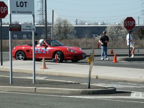 2001 Mercury Grand Marquis - A red convertible sports car is seen at an event with orange cones and stop signs visible.