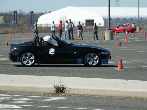 2001 Mercury Grand Marquis - A black convertible sports car with racing number 2 participates in an autocross event.