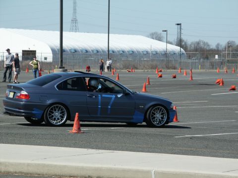 2001 Mercury Grand Marquis - BMW 3 Series coupe navigates an autocross course marked with cones.