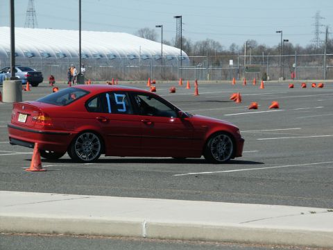 2001 Mercury Grand Marquis - A red sedan with the number 19 on its window is positioned on an asphalt lot marked with cones.