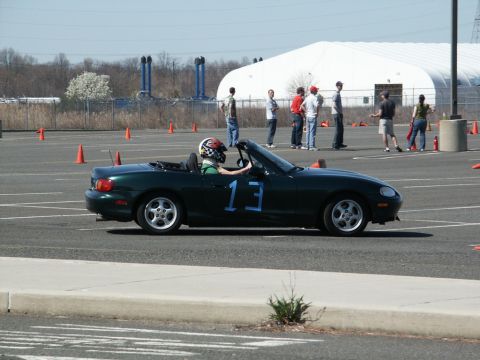 2001 Mercury Grand Marquis - A dark green convertible sports car, identified by the number 13 on its door, participates in an autocross event.