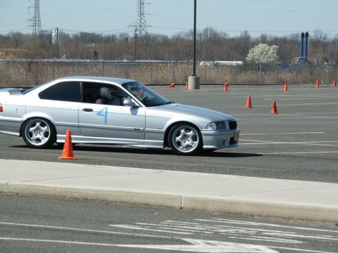 2001 Mercury Grand Marquis - A silver coupe navigates an autocross course marked by orange cones.