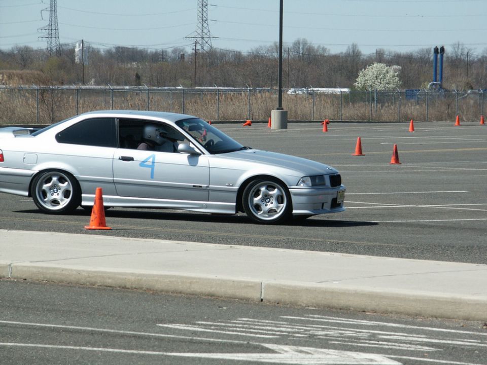 Silver coupe with blue number 4 on door at autocross event