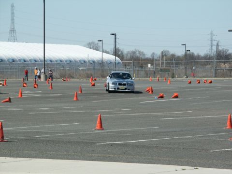 2001 Mercury Grand Marquis - A silver sedan drives through an autocross course marked by orange cones.