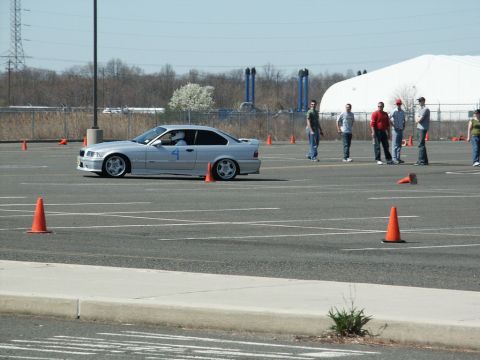 2001 Mercury Grand Marquis - A silver BMW M3 E36 navigates a course marked by orange cones during an event.