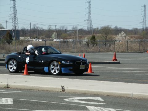 2001 Mercury Grand Marquis - A black convertible sports car navigates a course marked by orange cones.