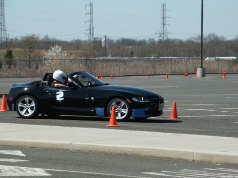 2001 Mercury Grand Marquis - A black convertible sports car with blue accents and the number 2 on its door navigates a course marked by orange cones.