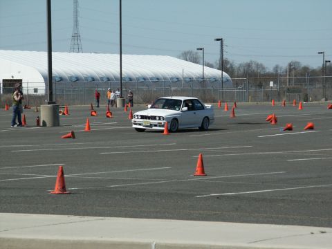 2001 Mercury Grand Marquis - A white BMW E30 M3 navigates an autocross course marked by orange cones.
