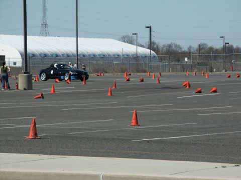 2001 Mercury Grand Marquis - Sports car navigates a cone course, likely for an autocross event.