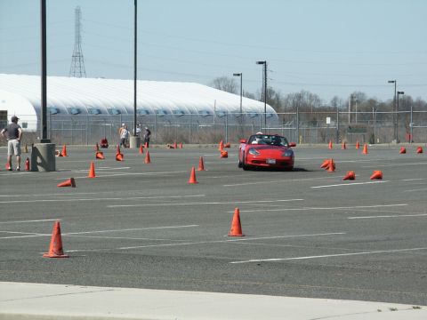2001 Mercury Grand Marquis - Sports car driving through an autocross course marked by orange cones.