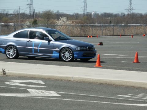 2001 Mercury Grand Marquis - A BMW 3 Series Coupe navigates a course marked by orange cones on a sunny day.