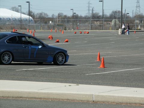 2001 Mercury Grand Marquis - A blue coupe with racing numbers taped to its side is parked in a lot marked with cones, likely for an autocross event.