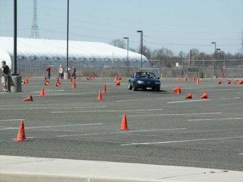 2001 Mercury Grand Marquis - A dark convertible navigates a course marked by orange cones during an event.