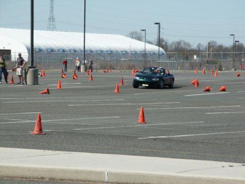 2001 Mercury Grand Marquis - A green convertible is driven through a parking lot marked with cones for an autocross event.