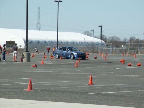 2001 Mercury Grand Marquis - A blue coupe, marked with racing number 17, maneuvers through an autocross course marked by orange cones.