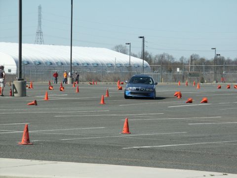 2001 Mercury Grand Marquis - A blue sedan maneuvers through an autocross course, its grille clearly visible.