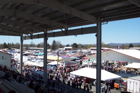 2001 Ford Crown Victoria - A busy outdoor market with many vendors and shoppers under a bright blue sky.