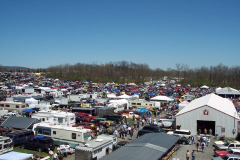 2001 Ford Crown Victoria - A vast outdoor gathering of vehicles and vendors under a clear blue sky.